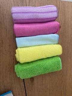 Microfiber cleaning cloths in different colors used for hygienic home cleaning