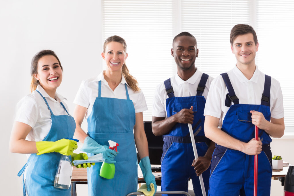 A cheerful bond cleaning Canberra team of professionals in uniforms, ready to provide exceptional cleaning services.